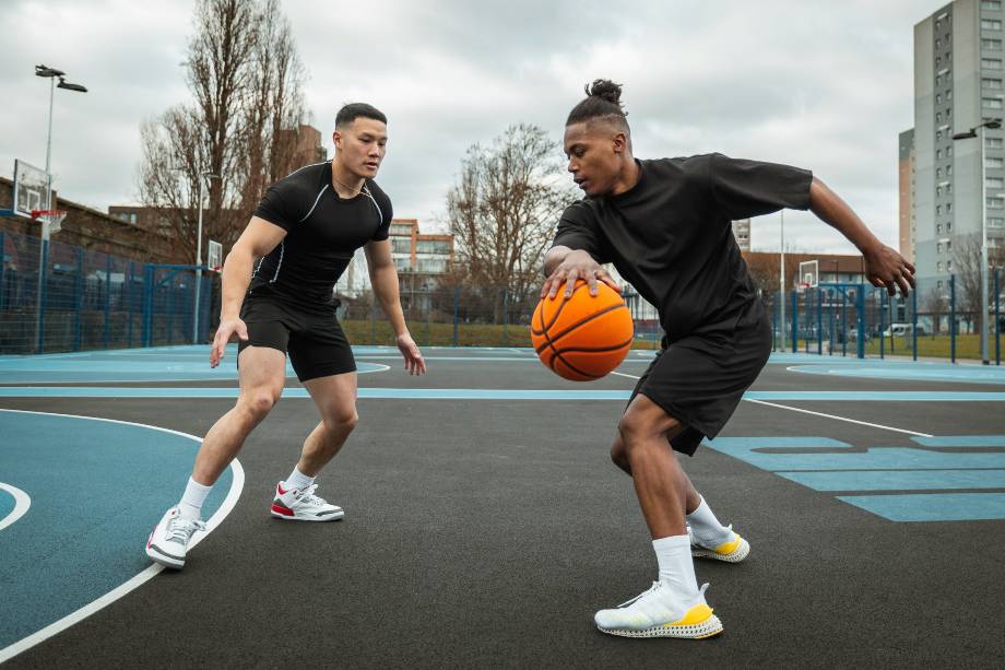 Two men play basketball