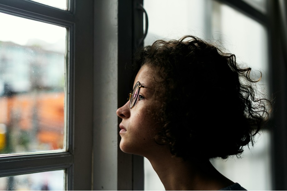 a woman look out the window