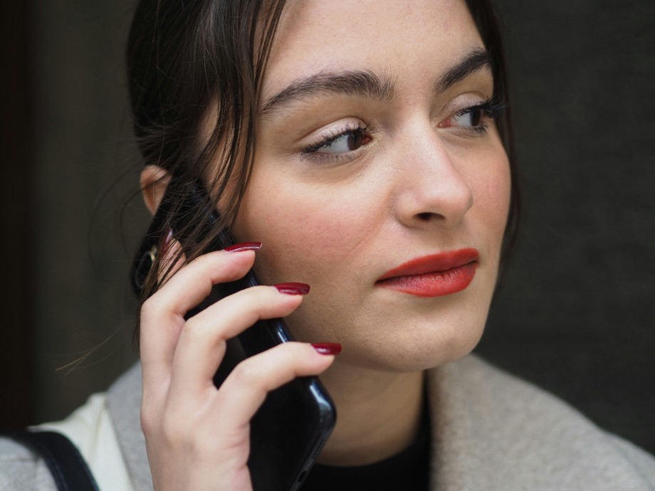 a woman use call recorder to talk with someone via phone
