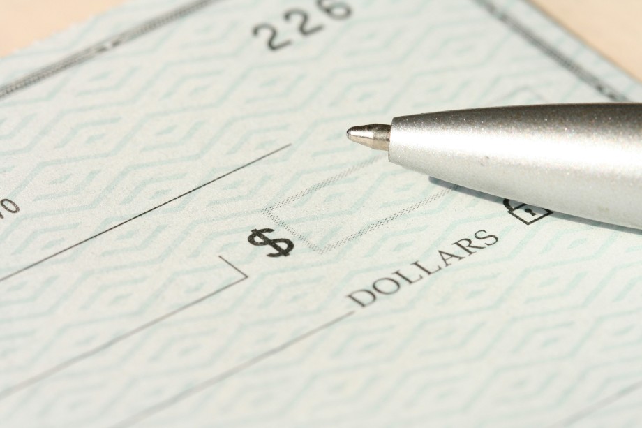 A ball pen on a personal paper check