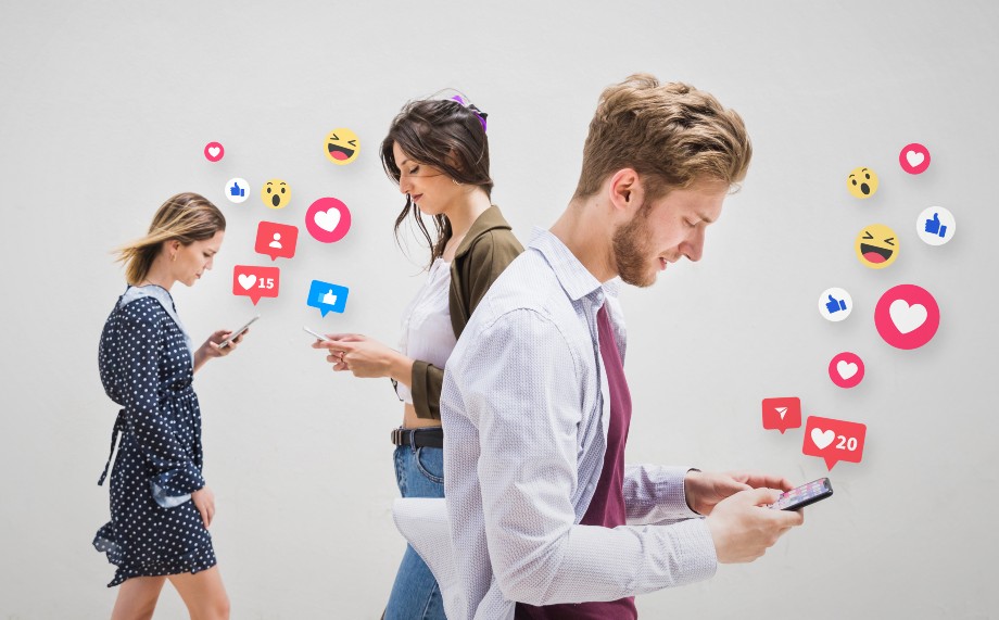 Three people looking into their smartphone screens and using social media