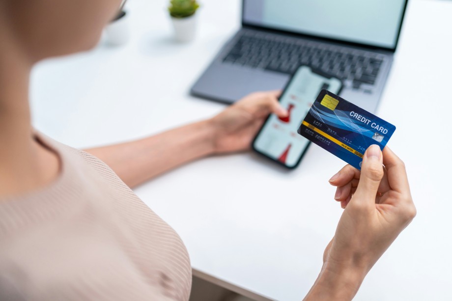 a woman with a credit card at hand