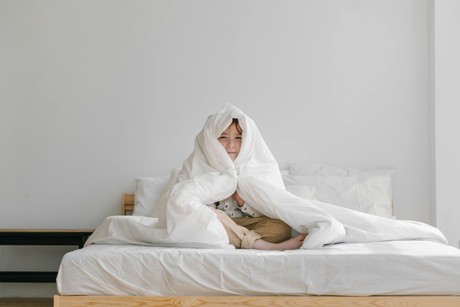 a Boy Covering His Head with a Blanket